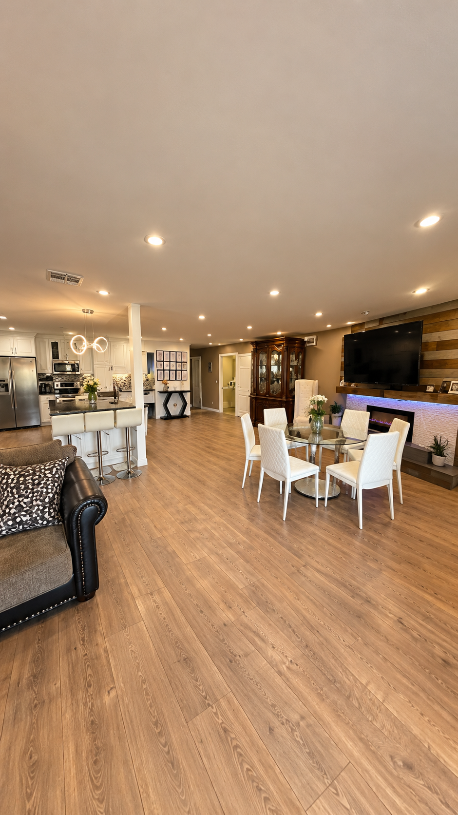 Open dining area with a family-style dining table and white upholstered chairs